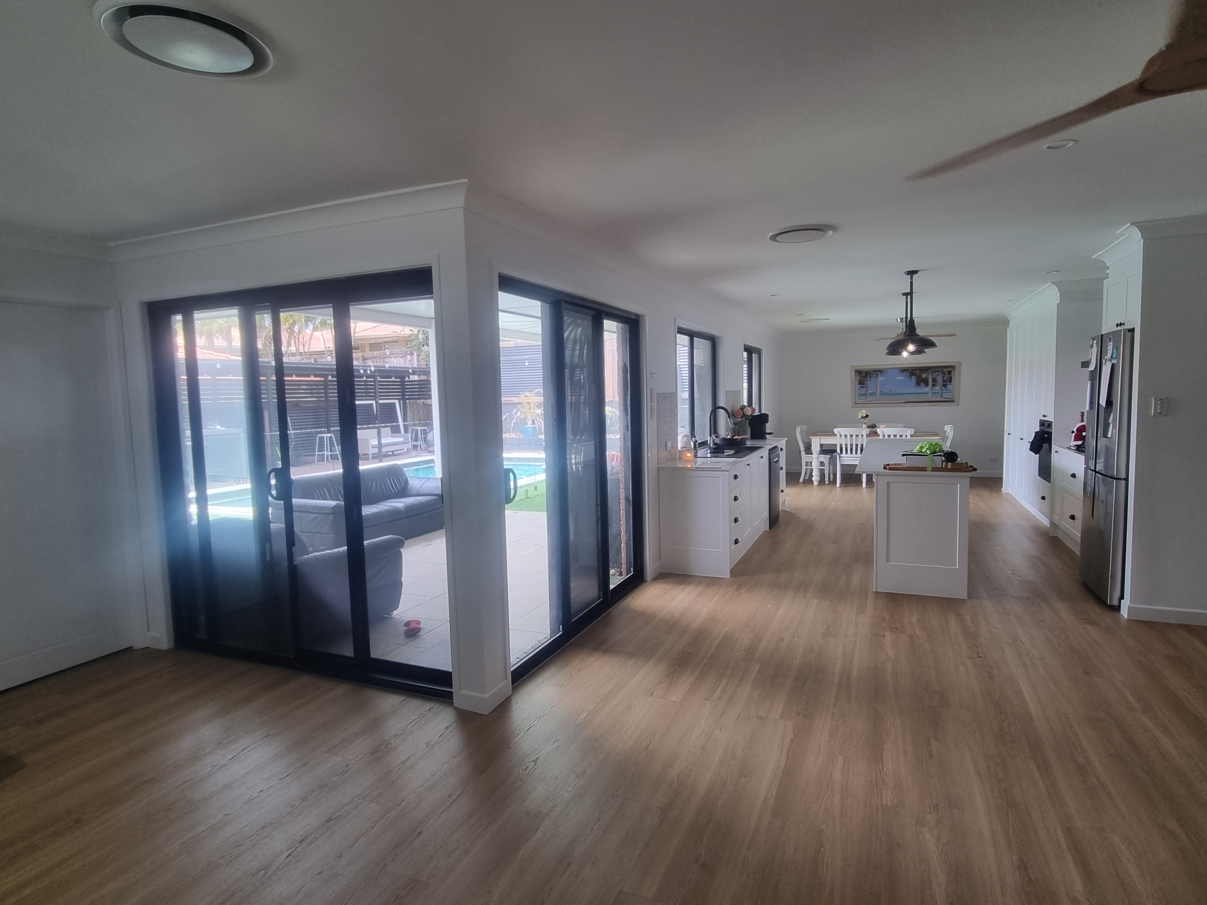 Completed kitchen and living area opening to the pool
