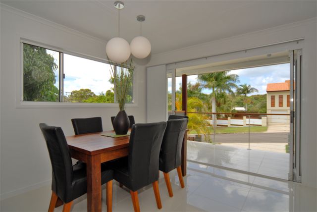 Bright dining space opening to the deck after renovation