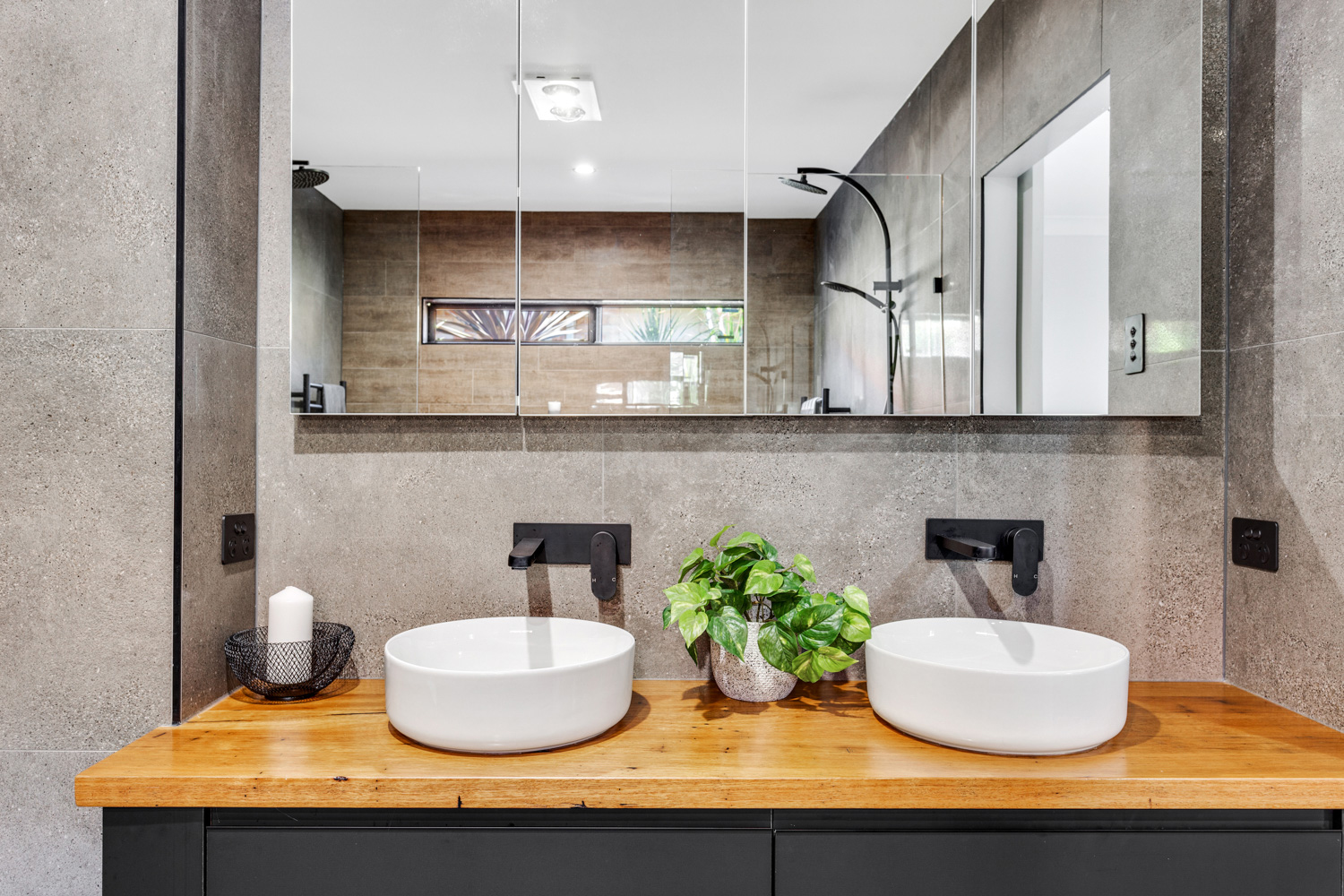 Completed bathroom with twin basins and timber vanity