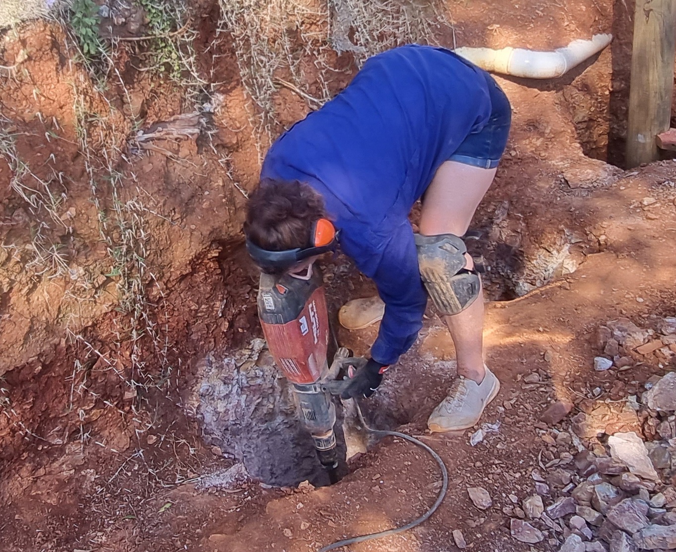 Stacey using a jackhammer during excavation works